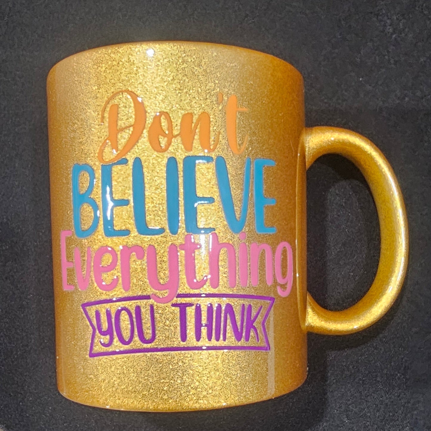 Gold "Don't believe everything you think" mug