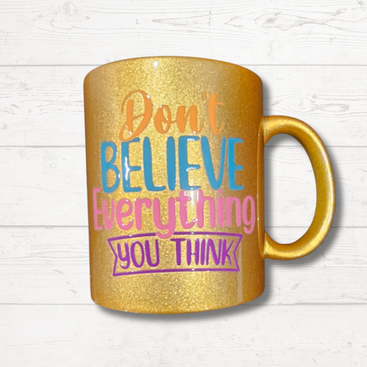 Gold "Don't believe everything you think" mug